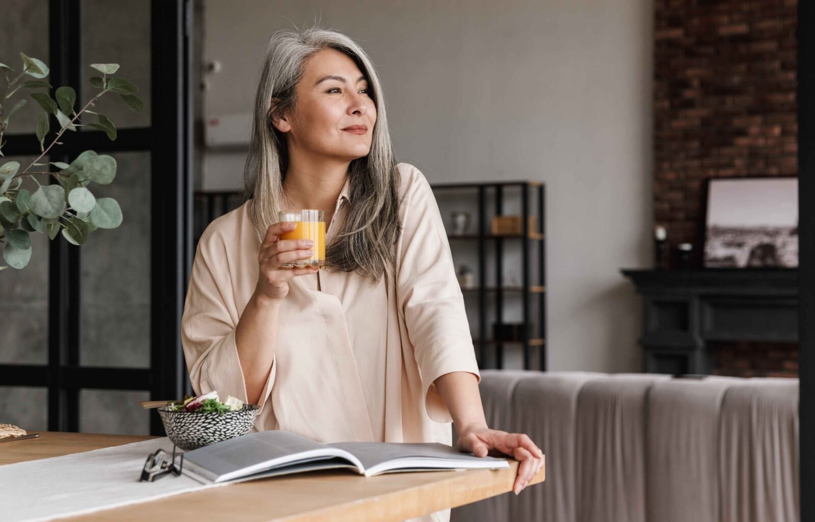 woman reading book psychology of money with a cup of coffee