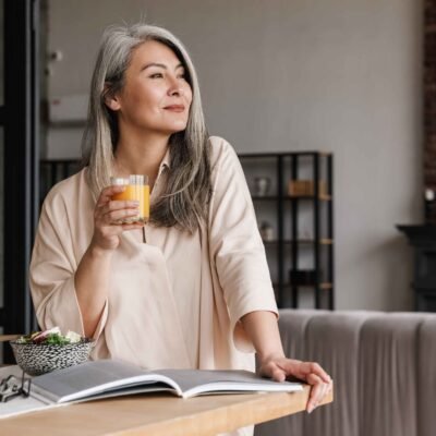 woman reading book psychology of money with a cup of coffee
