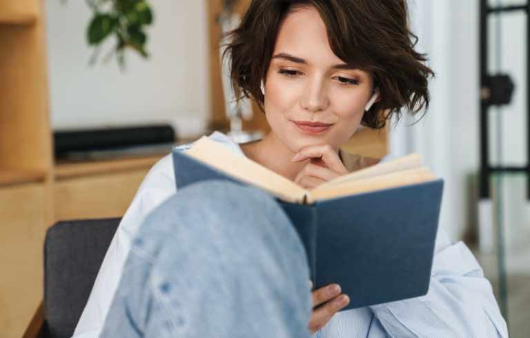 The woman reads a book. On how to get over the ex