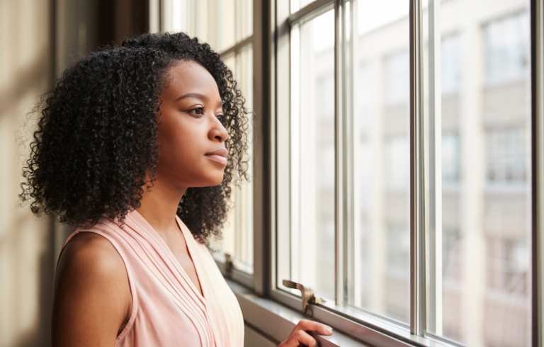 woman thinks on Why You Still Dream About Your Ex